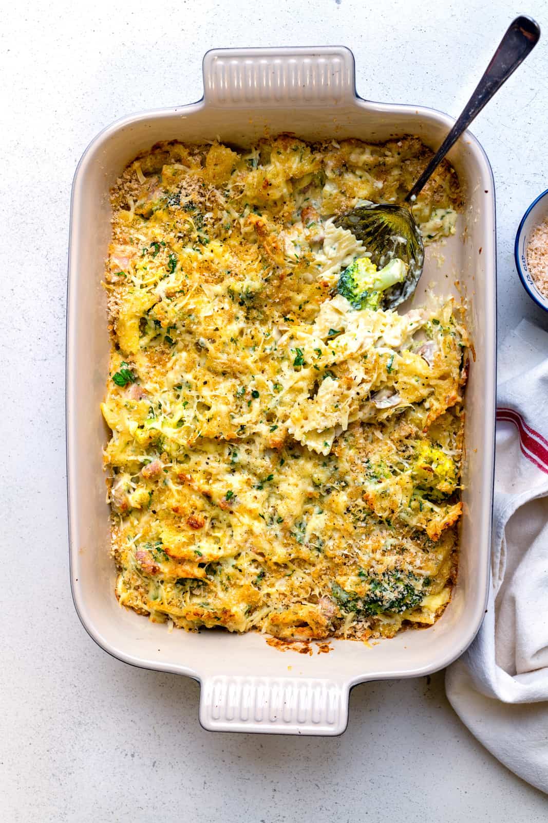 Leftover turkey casserole with broccoli, pasta and creamy sauce baked in oven