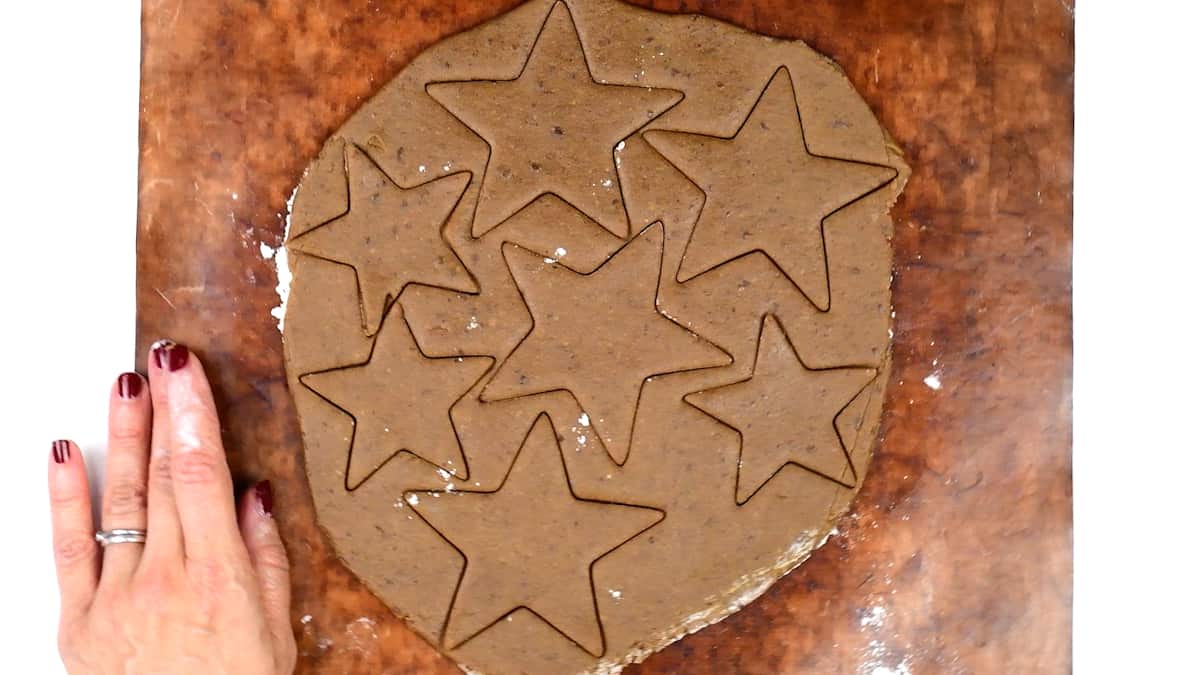 cutting out star shaped gingerbread cookies