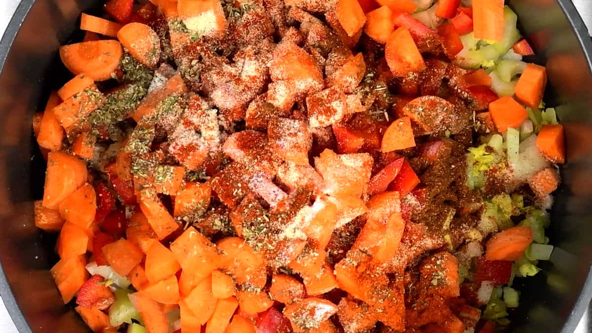 onions, celery, carrots, bell pepper, spices and seasonings in a large pot