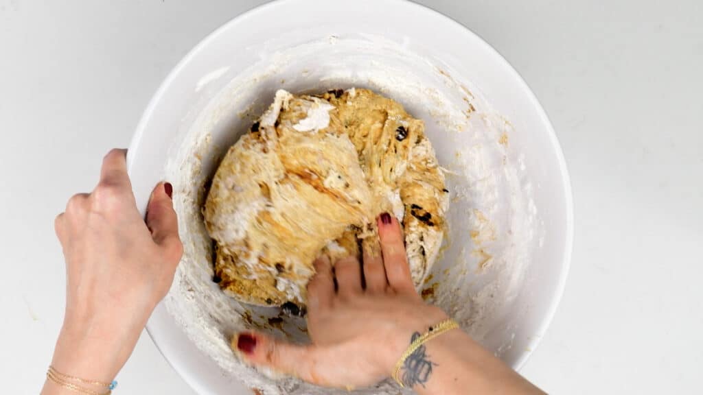 Mixing sourdough dough in a bowl