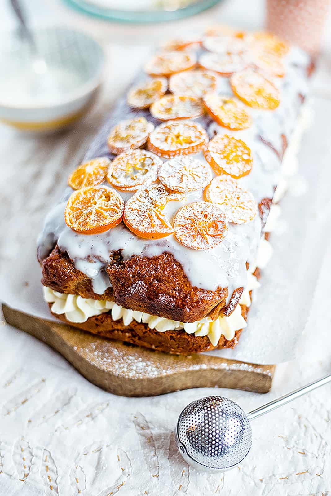 Orange olive oil cake filled with cream and decorated with orange slices