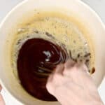 Stirring melted butter and chocolate in a mixing bowl