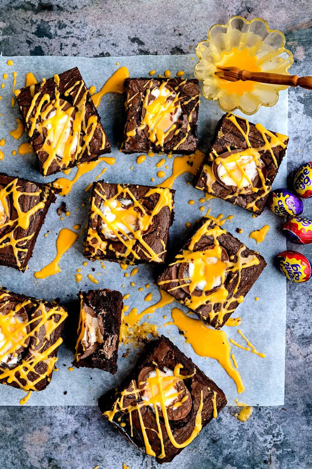 Overhead view of sliced Cadbury's Creme Egg brownies drizzled with yellow icing