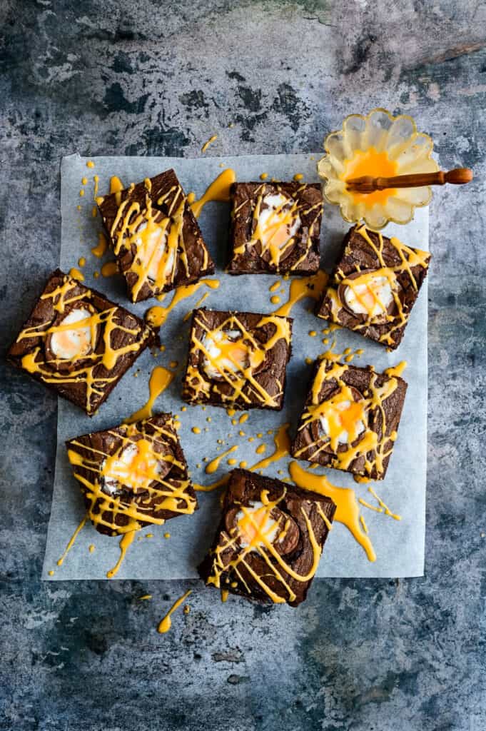 Cadbury's Creme Egg brownies with yellow glaze drizzled over the top