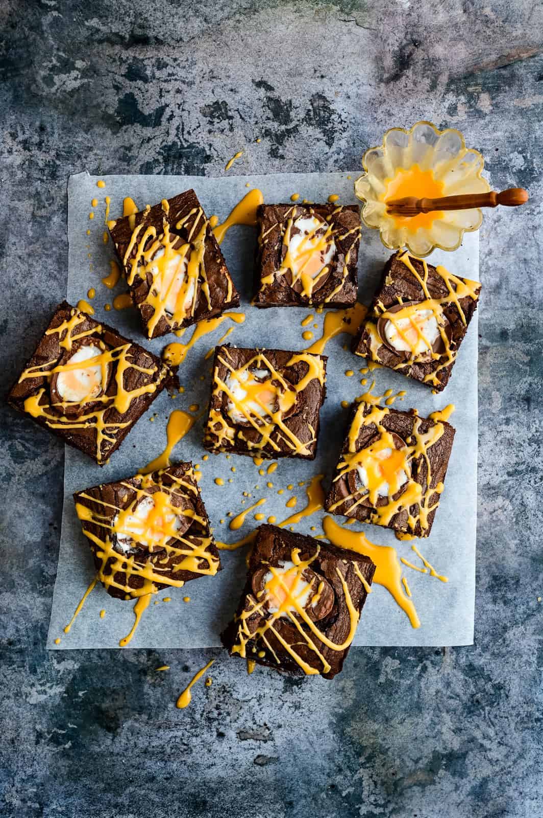 Overhead photo of Creme Egg Brownies drizzled with yellow icing 
