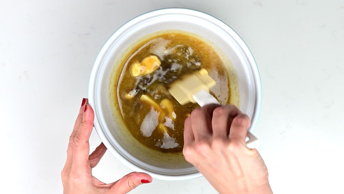 stirring melted butter and chocolate together in a bowl