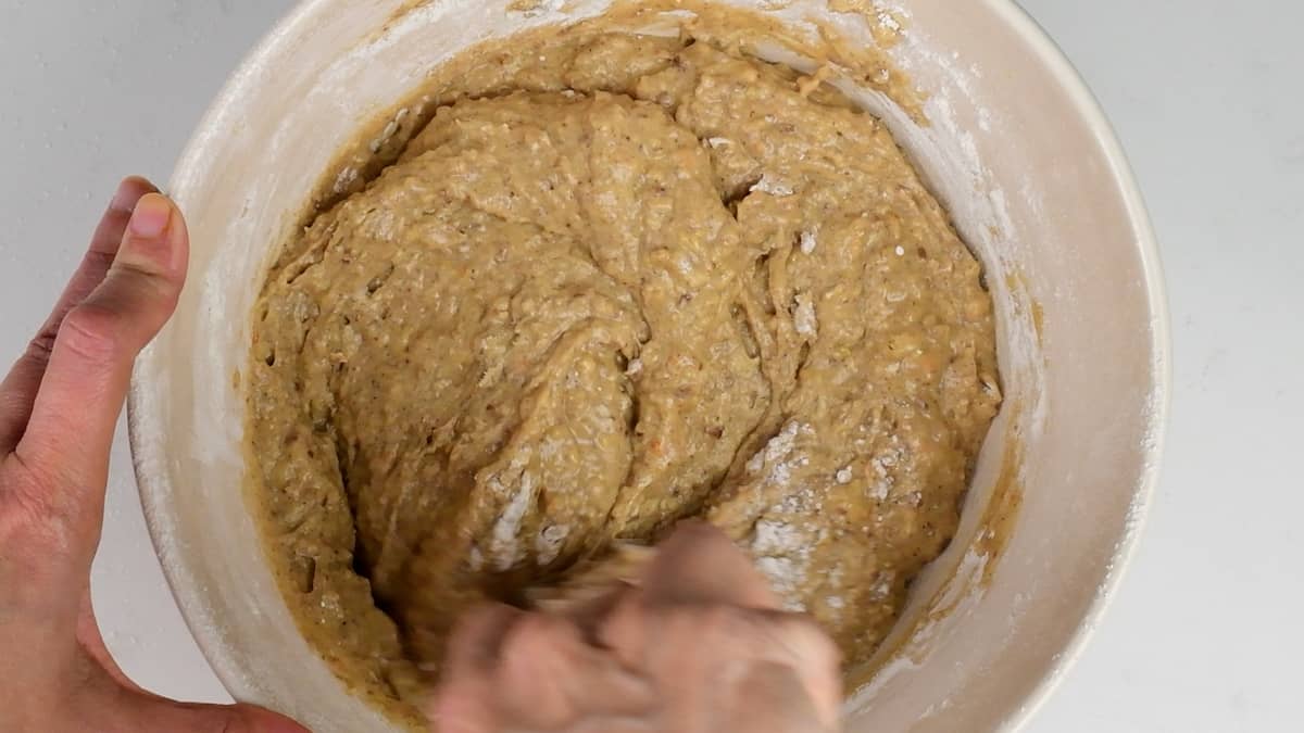 mixing batter for orange cake in a large bowl
