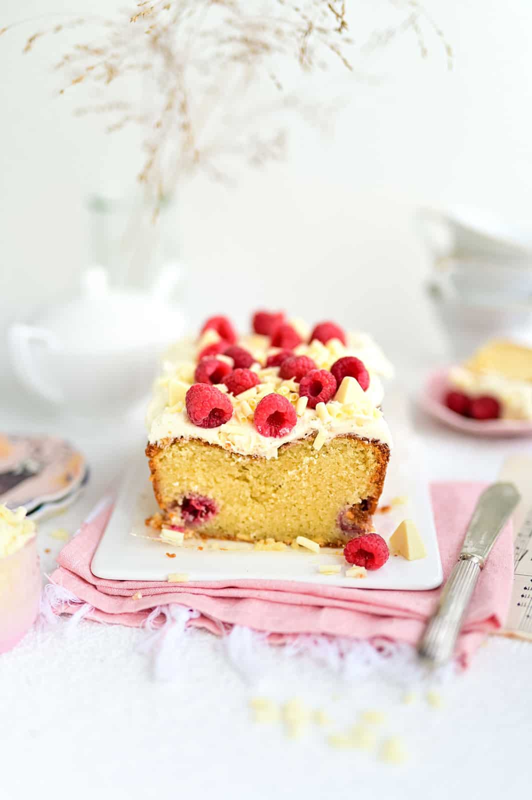 White Chocolate Raspberry Loaf Cake with sliced cut to show texture