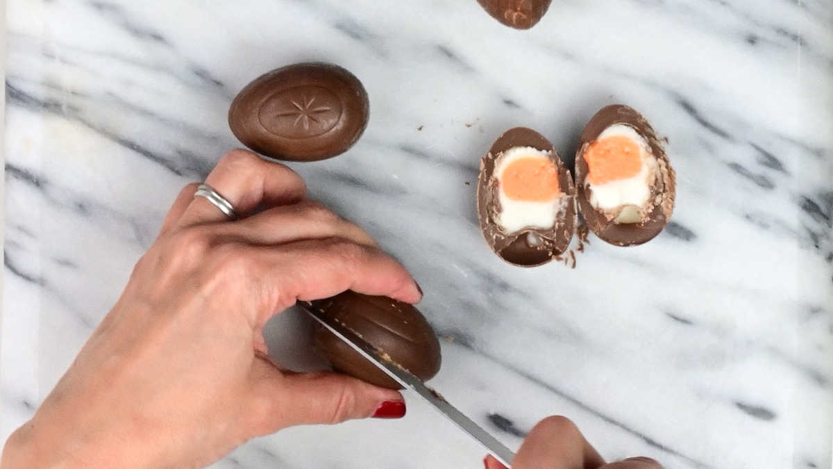 slicing Creme Eggs in half on a marble board