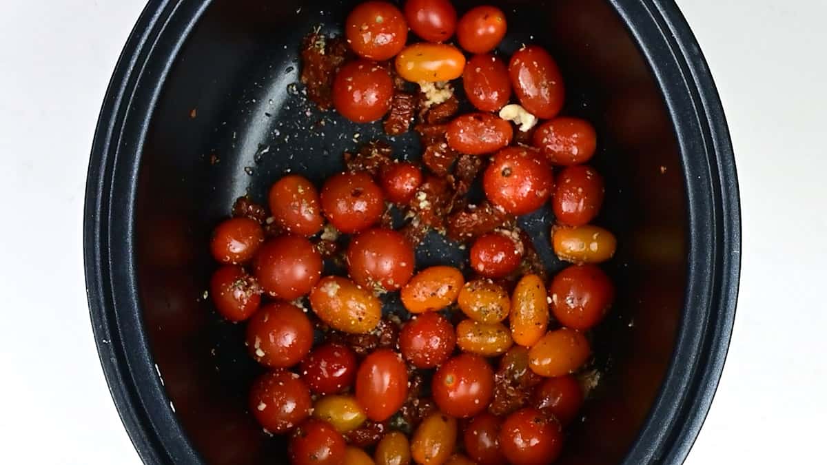 Cherry tomatoes with garlic, herbs and seasoning in a slow cooker