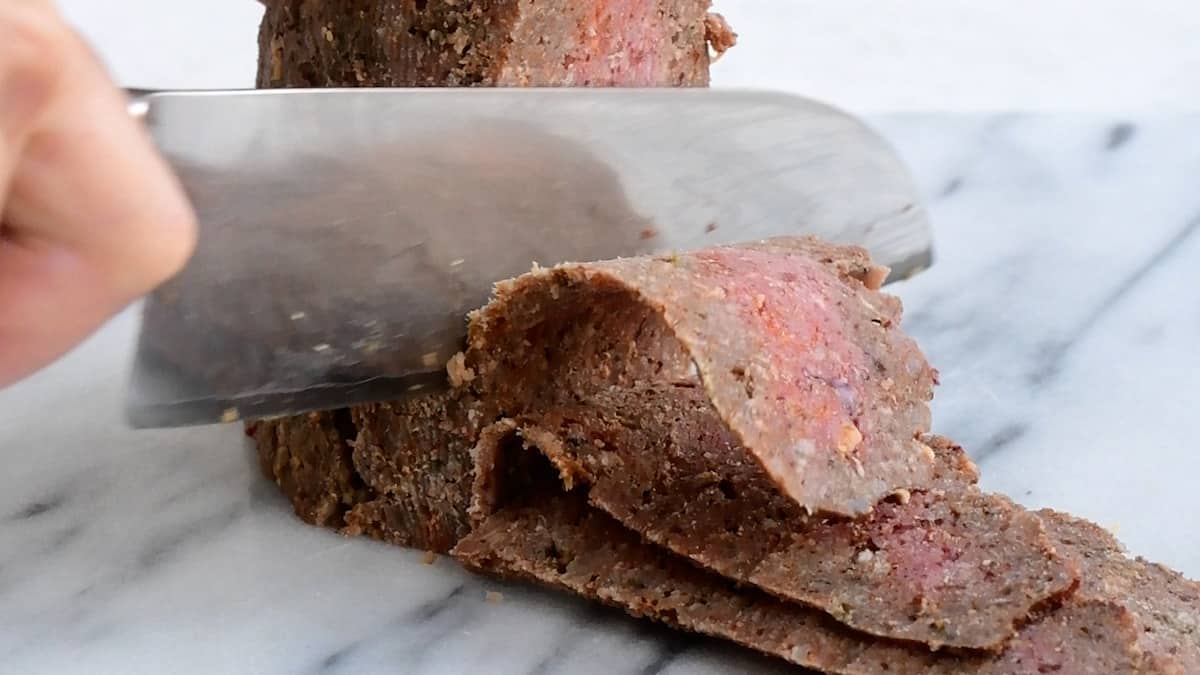 Slicing homemade beef doner with a knife