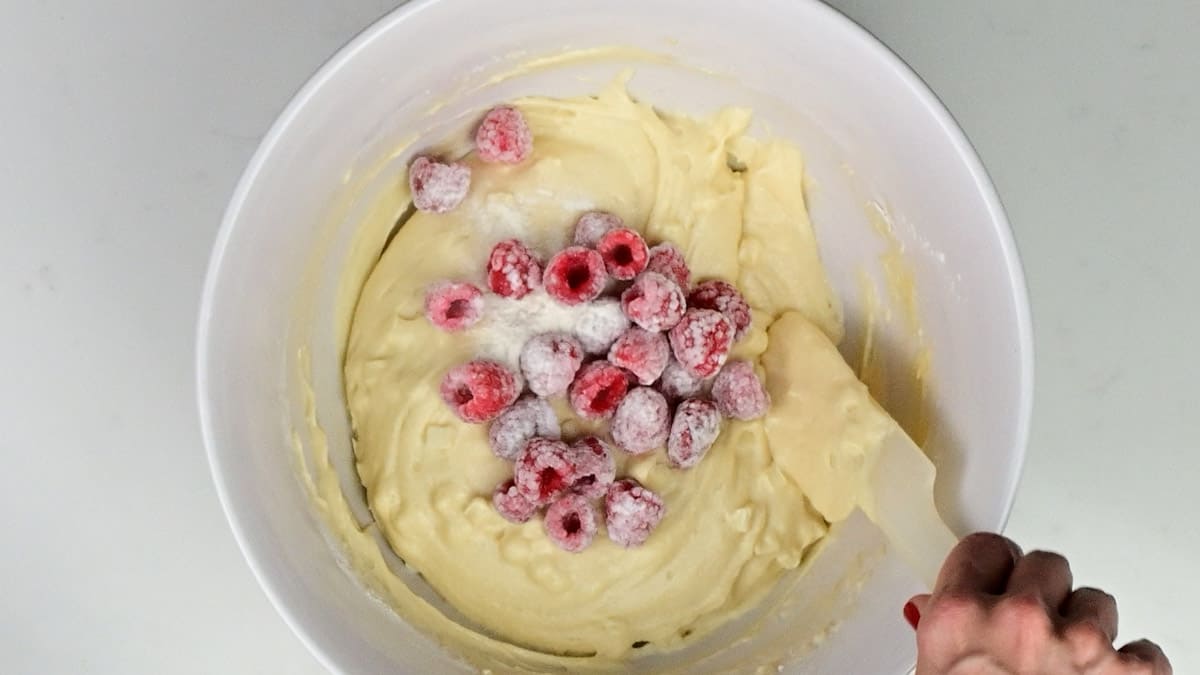 folding fresh raspberries into cake batter