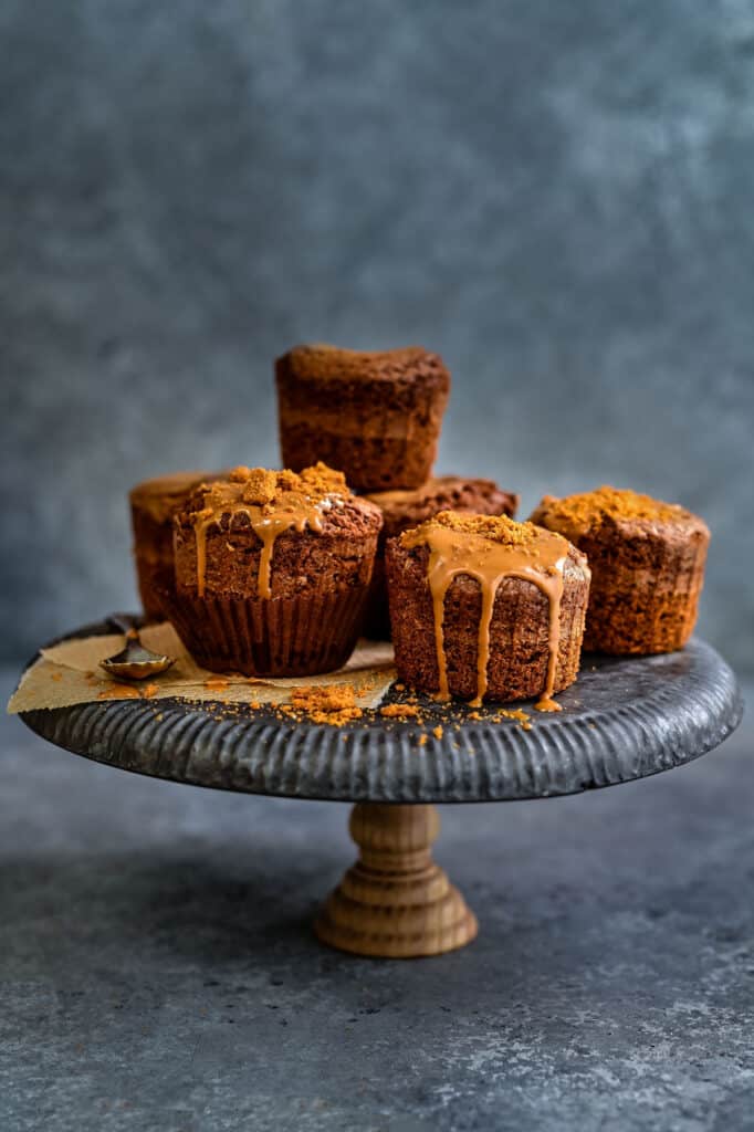 Biscoff muffins on a cake stand drizzled with Lotus Biscoff spread 