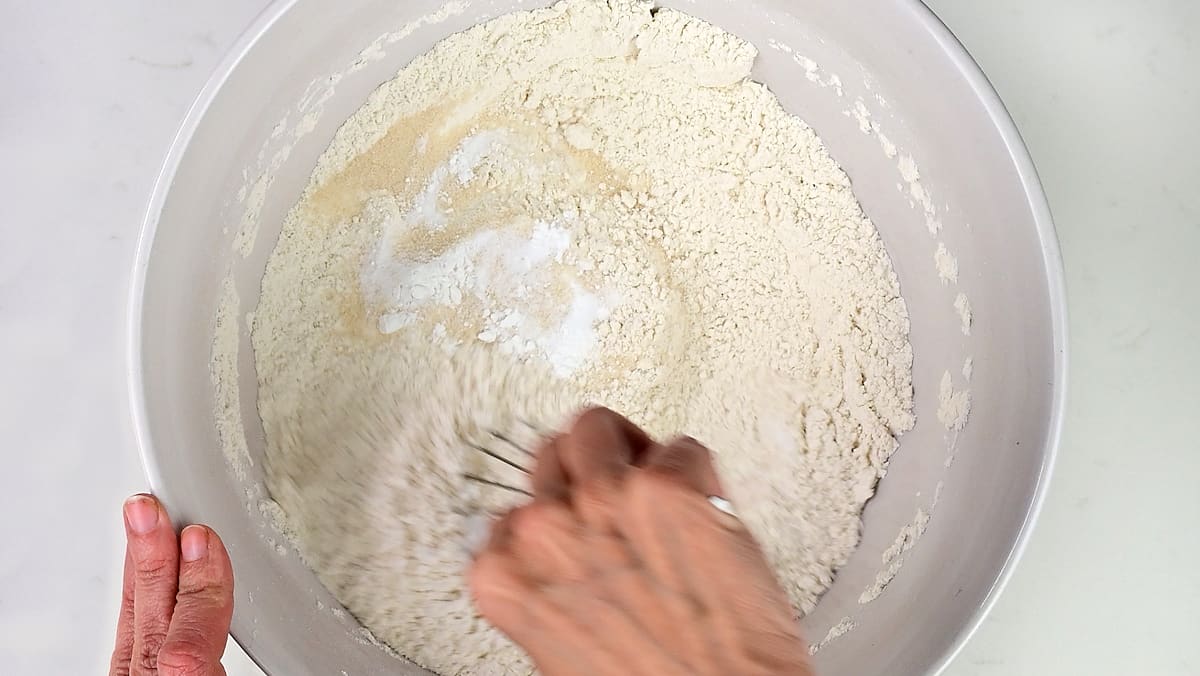 Stirring flour, sugar, salt, baking soda and baking powder together in a mixing bowl