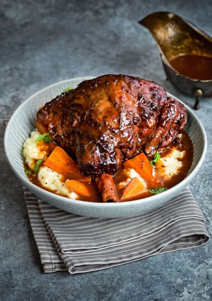 Slow cooked lamb shank served with red wine sauce and mash