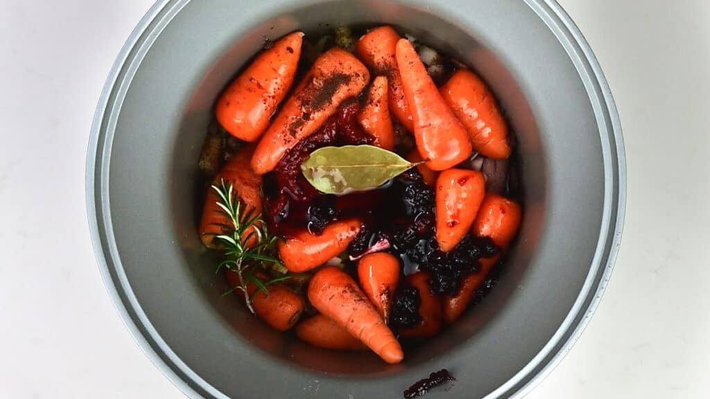 Red wine, onions, celery, carrots in a slow cooker