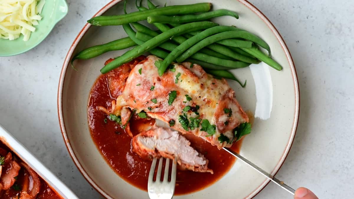 Hunter chicken on a plate with a side of green beans
