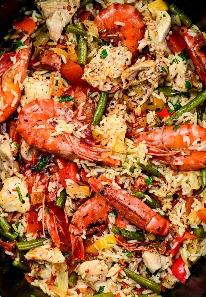 close up on a slow cooker containing Mixed Paella with shrimp, chicken and chorizo