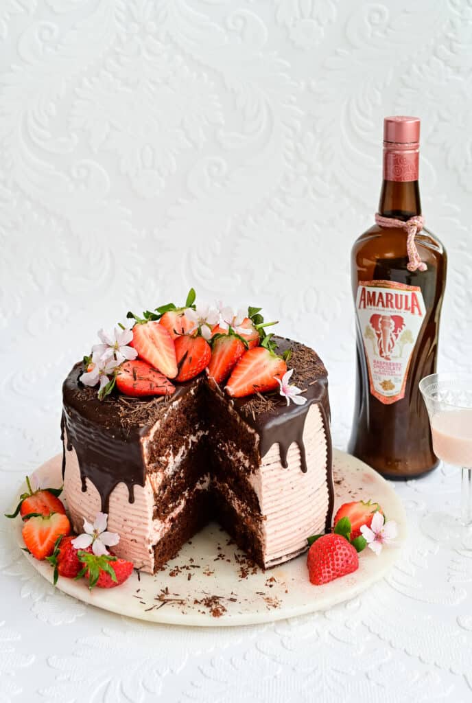 strawberry chocolate cake with large slice cut out to show interior