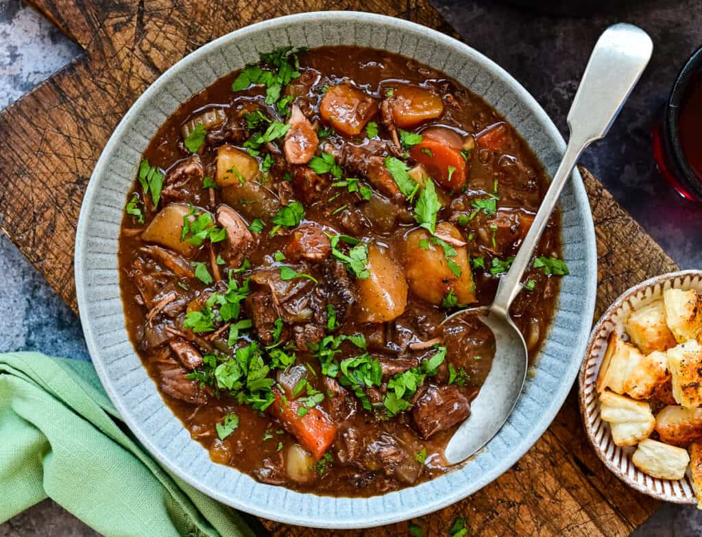 serving of traditional beef stew in a grey bowl