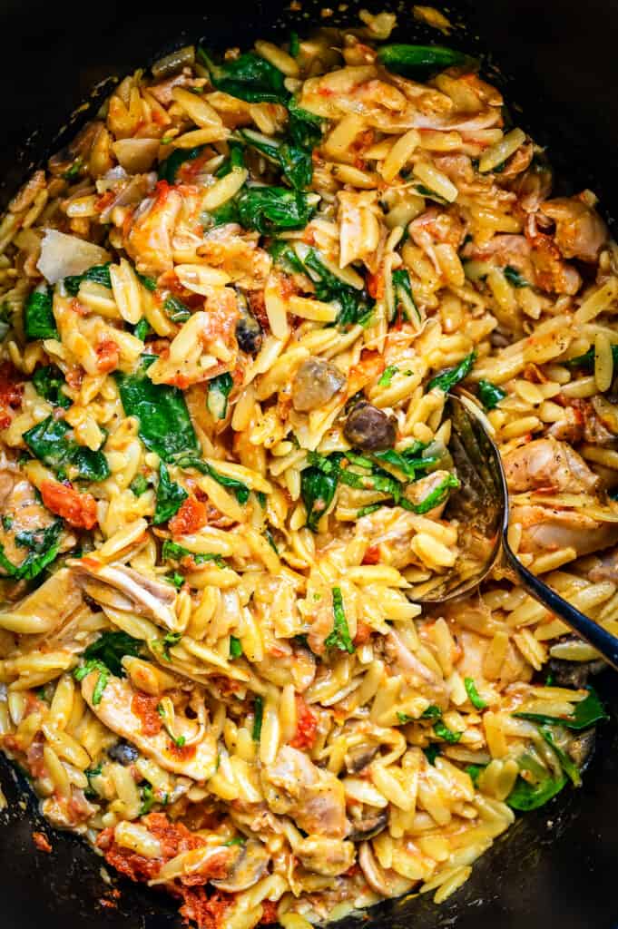 Close up on Crockpot Tuscan chicken pasta with orzo and spinach