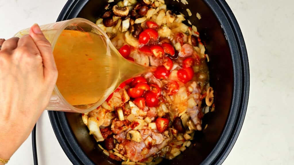 Chicken, onions, garlic, mushrooms, cherry tomatoes and stock in a crock pot