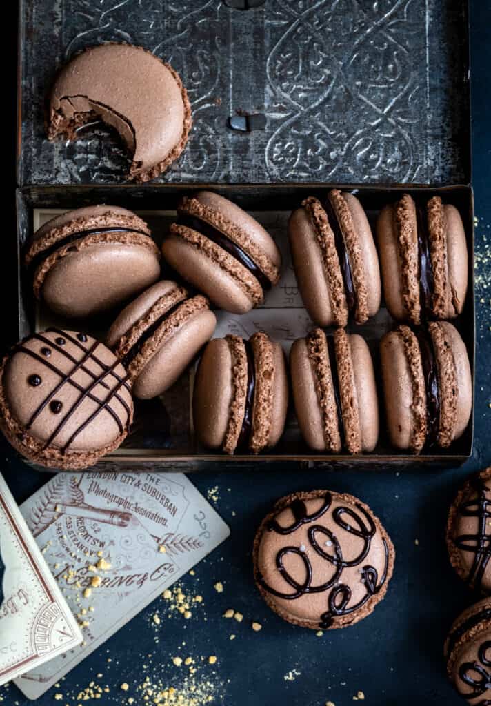 overhead view of chocolate macarons in a small tin