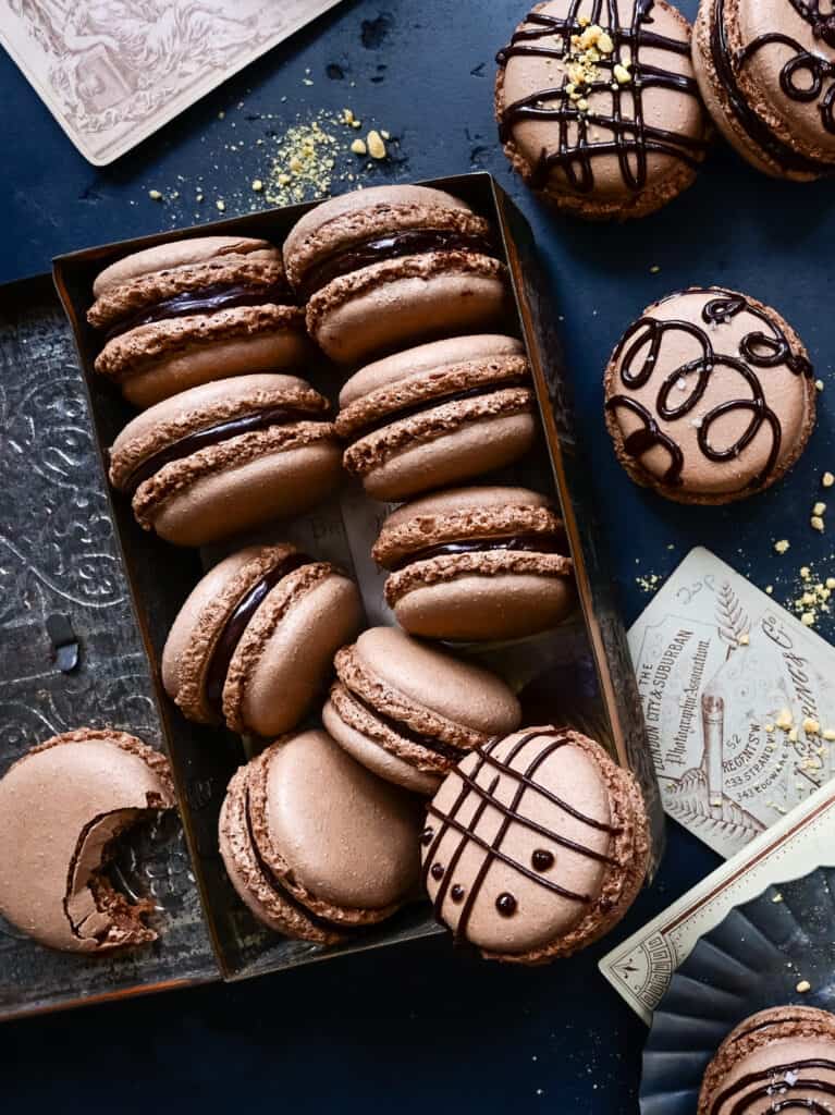 Chocolate macarons filled with ganache and drizzled with chocolate