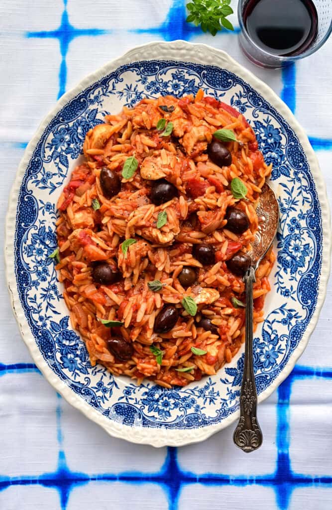 Chicken cooked with orzo and tomato sauce