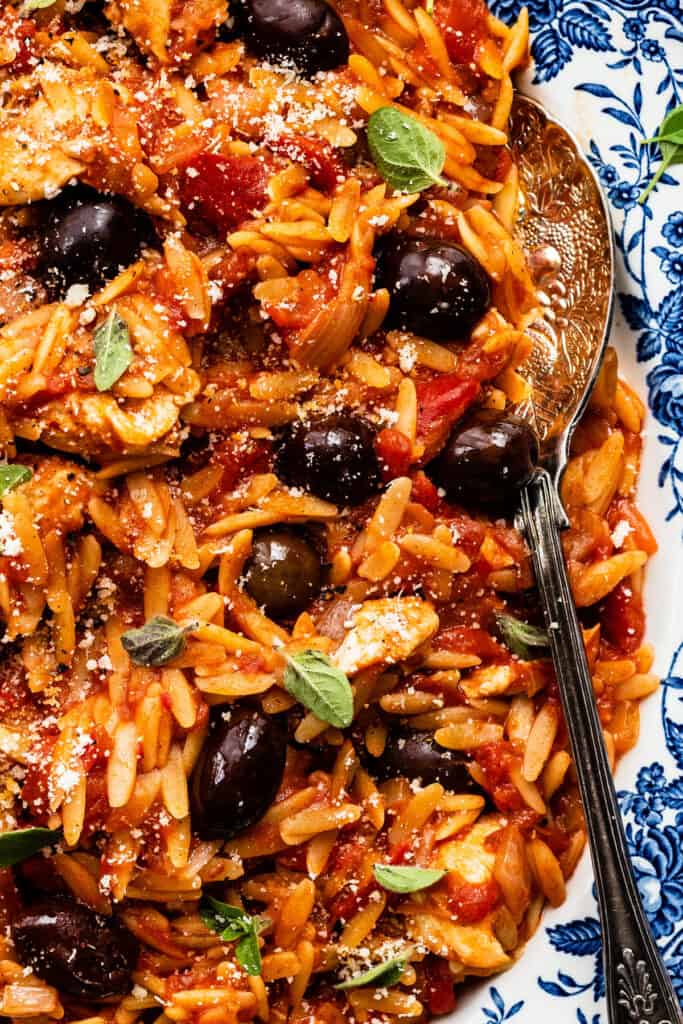 Close up on Greek orzo and chicken with olives