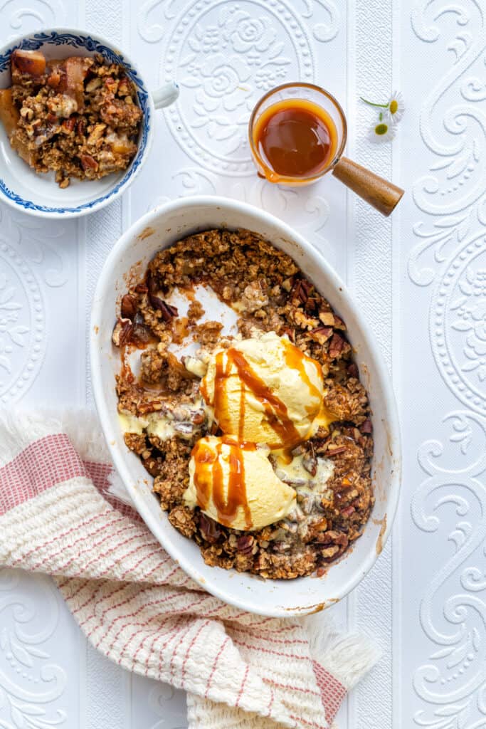 Overhead photo of apple crumble with oat topping served with ice cream