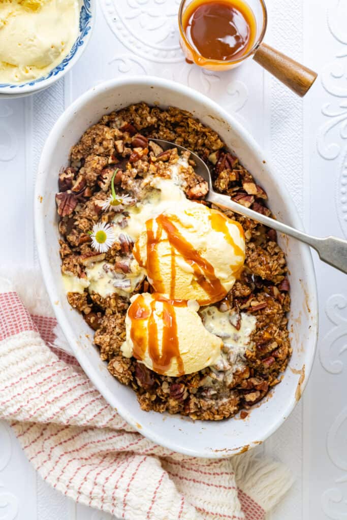 Overhead photo of apple crumble with oat topping served a la mode