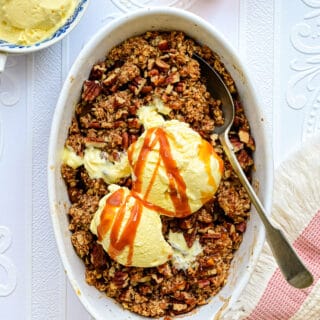 Apple Crumble served with ice cream and caramel sauce