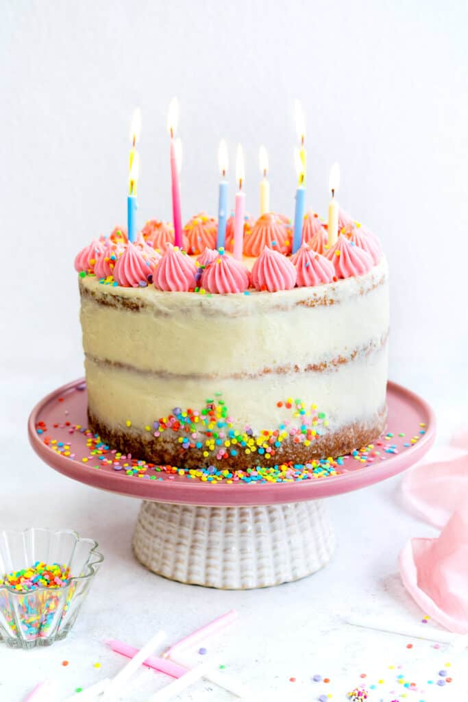 Vanilla sprinkle birthday cake cake with lit candles