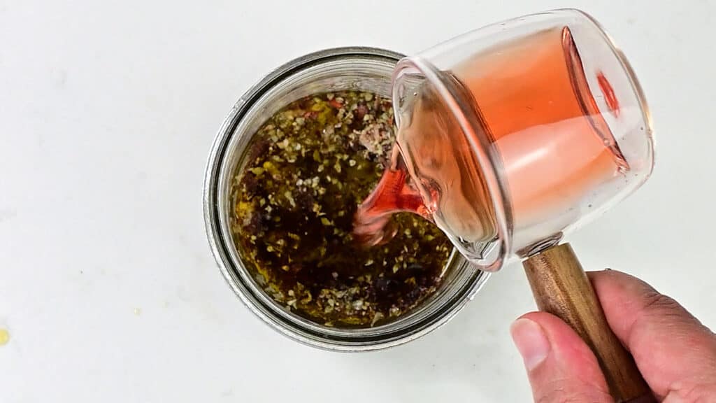 combining salad dressing ingredients in a jar