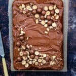 Overhead photo of a Malteser Traybake with chocolate frosting and Maltesers