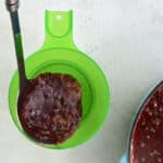 spooning jam into a jar