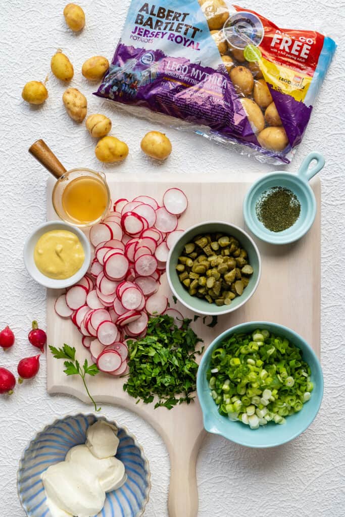 ingredients for new potato salad laid out on a cutting board