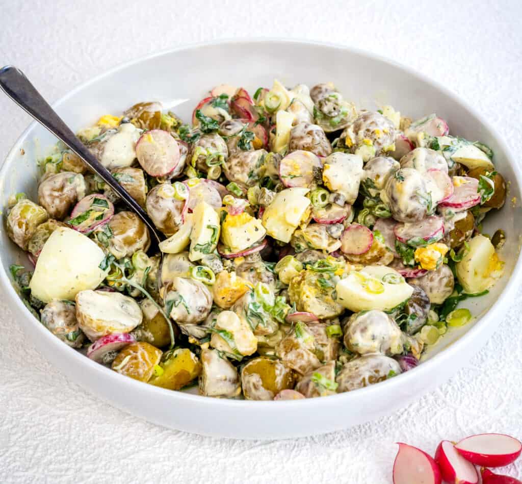 potato salad with eggs and creamy dressing in a bowl