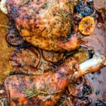 two roasted turkey legs on a roasting tray