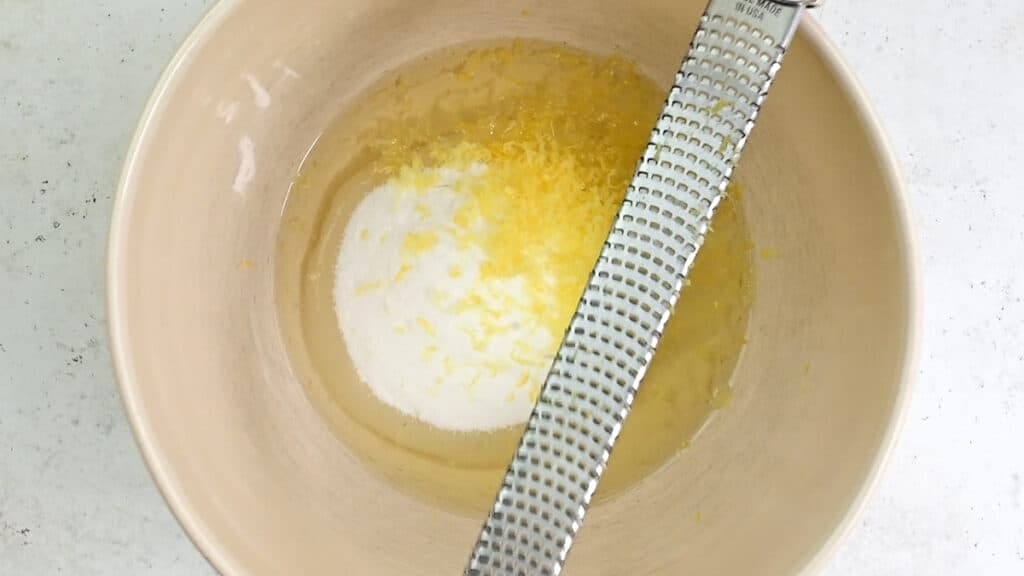 olive oil, sugar and lemon zest in a mixing bowl