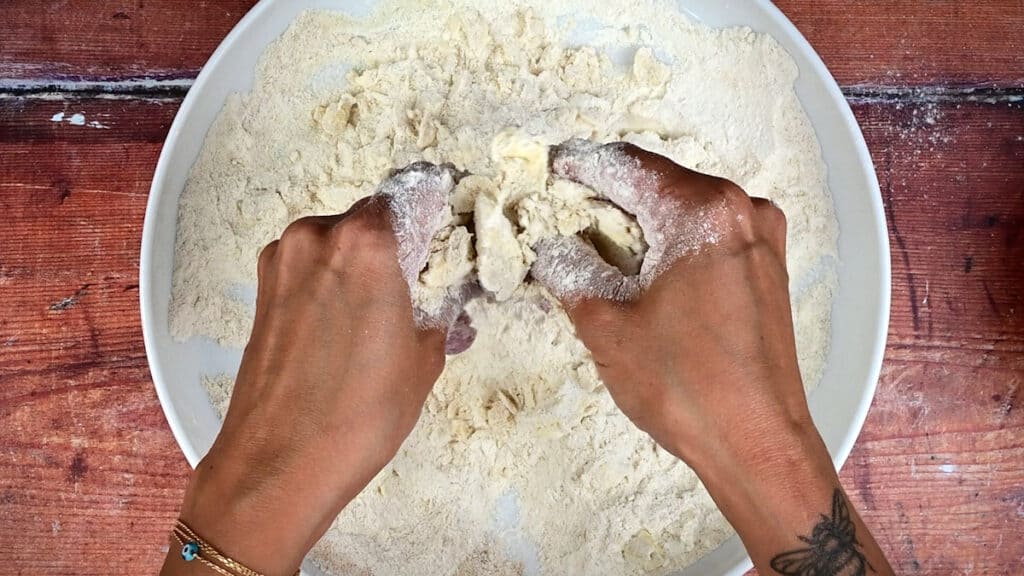 rubbing butter into flour and sugar to make crumble topping