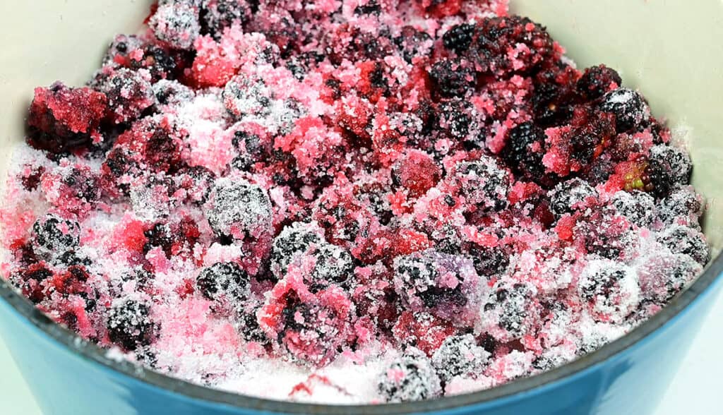 macerating blackberries in a pot