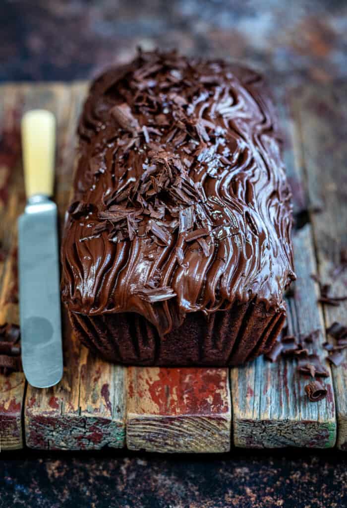 chocolate loaf cake with chocolate glaze decorated with chocolate shavings