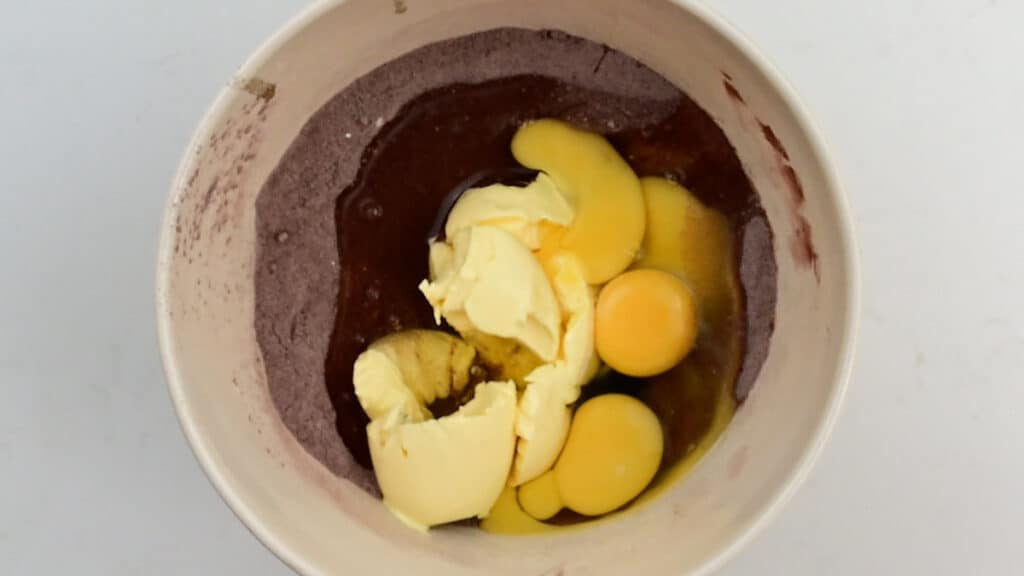 Ingredients for chocolate cake in a mixing bowl
