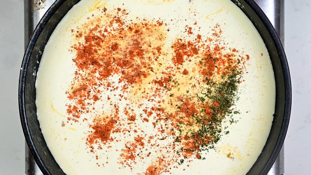 cream sauce with Cajun seasoning in a pan