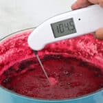 Checking jam temperature with a digital thermometer