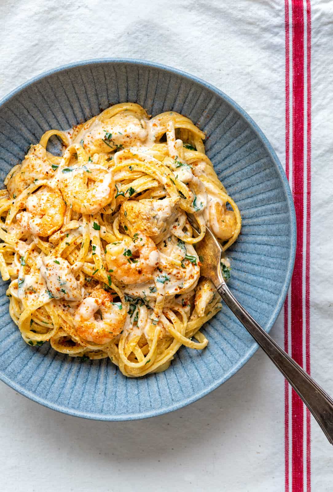 Linguine with Cajun Chicken and Shrimp Alfredo sauce in a grey bowl