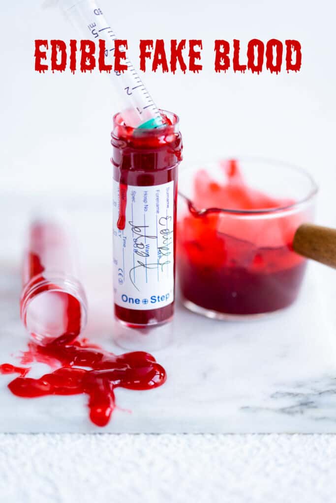 edible fake blood in a test tube with some spilled in foreground