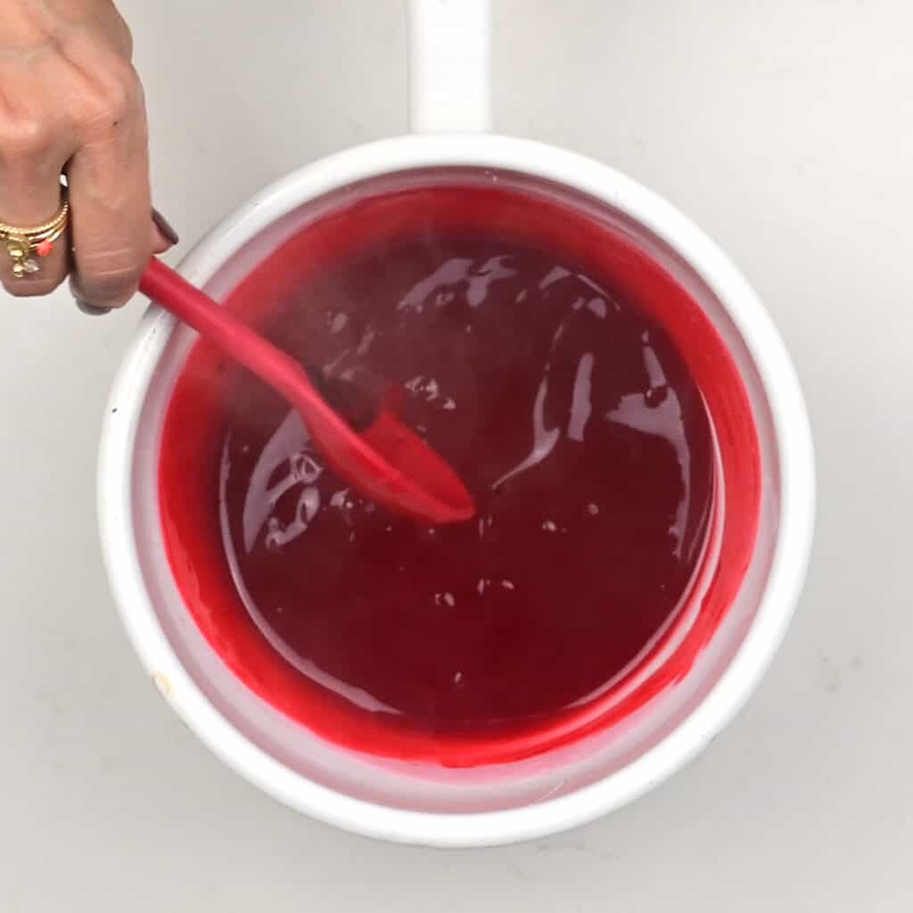 stirring edible fake blood in a saucepan